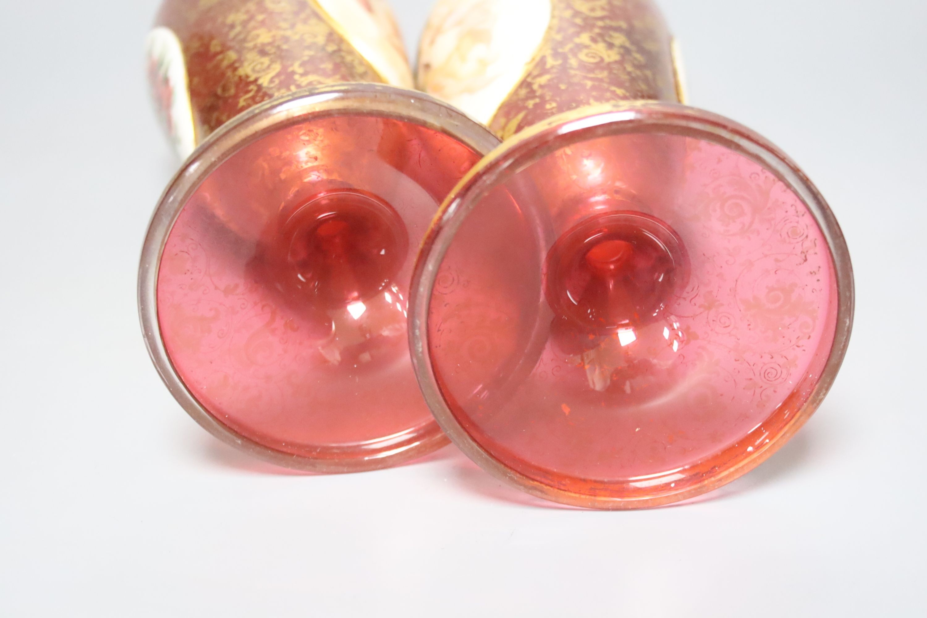 A pair of 19th century Bohemian enamelled and overlaid ruby glass vases 36cm